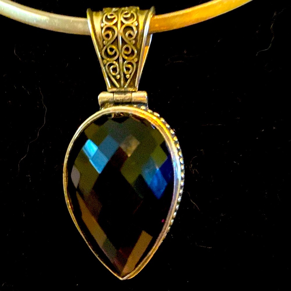 Elegant Purple Stone Encased in Silver Pendant